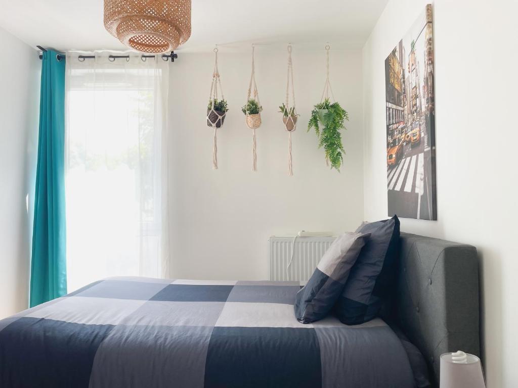 - une chambre dotée d'un lit avec des plantes sur le mur dans l'établissement Comfortable rooms in Nanterre University near La Defense Arena and Paris with very good wifi, à Nanterre