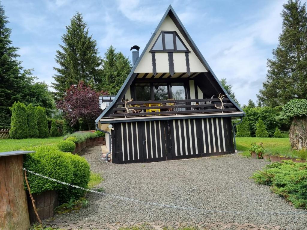 a small house with a gambrel roof at Ferienhaus Falknerei am Rennsteig in Winterstein