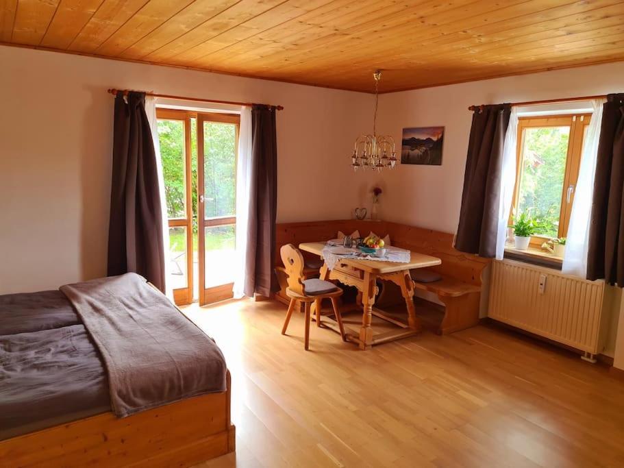 a bedroom with a table and a bed and a dining room at Ruhige Ferienwohnung in Bad Tölz in Bad Tölz