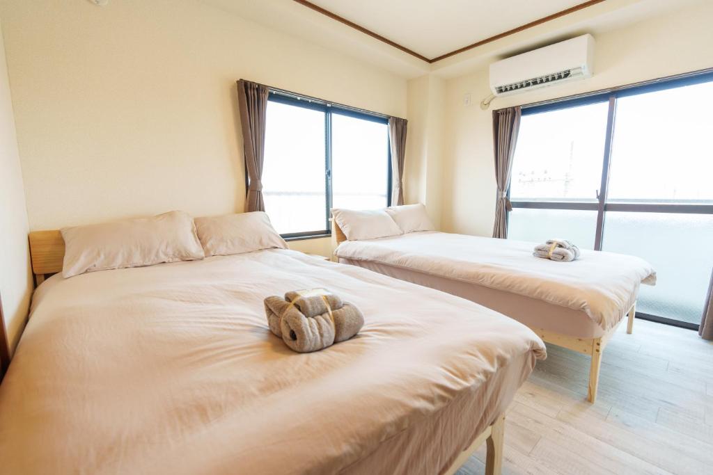 Postel nebo postele na pokoji v ubytování 静心宿Tranquil Retreat 4F晴空塔直达东京河景民宿