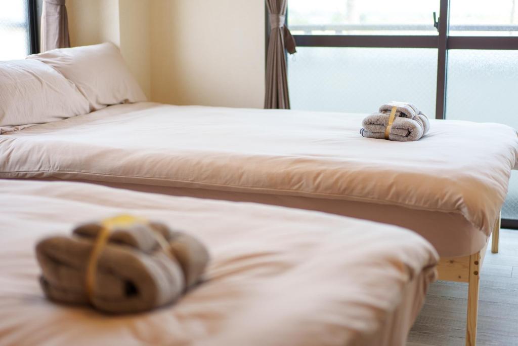 Postel nebo postele na pokoji v ubytování 静心宿Tranquil Retreat 4F晴空塔直达东京河景民宿