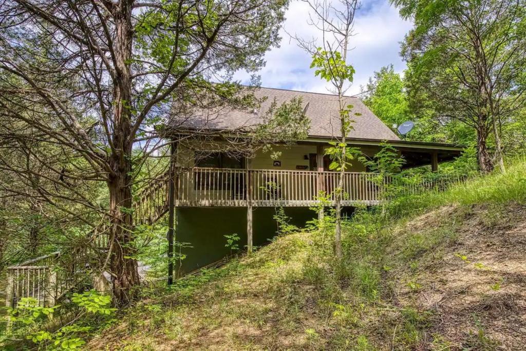 a house with a deck in the woods at Stairway To Heaven By Beyond Expectations in Sevierville