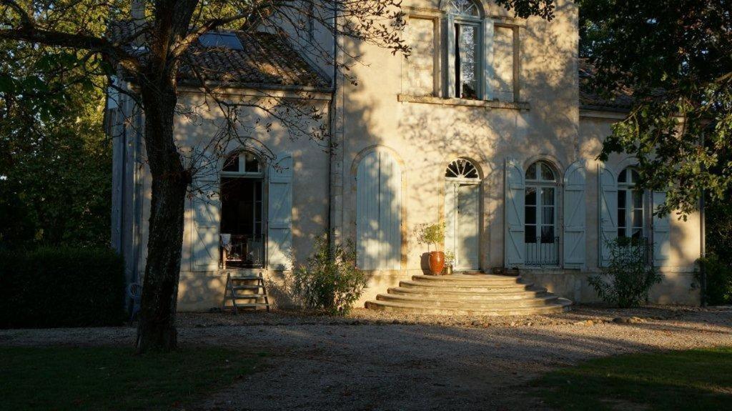 a white house with stairs in front of it at Manoir Larcouillet in Merles