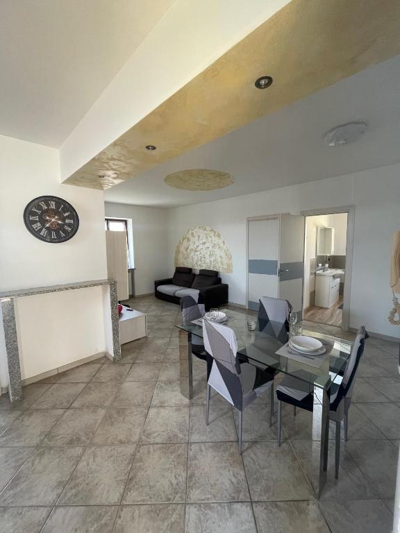 a living room with a table and chairs and a couch at Lecasedialex it Casa thas in La Loggia