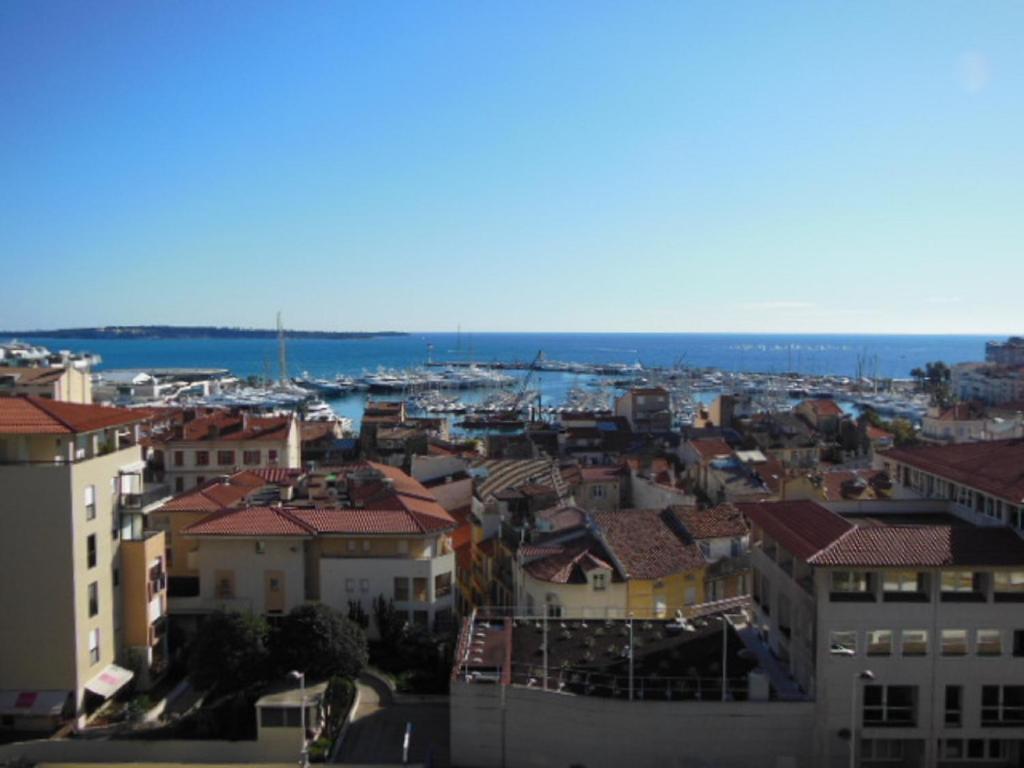 a view of a city with buildings and the ocean at 2, 3 and 4 bedroom sea view Forville Apartments 5 mins from the Palais in Cannes