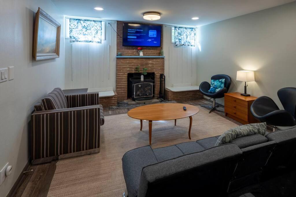 a living room with a couch and a table and a fireplace at Seaview Hideaway Heated Floors, free parking in Seattle