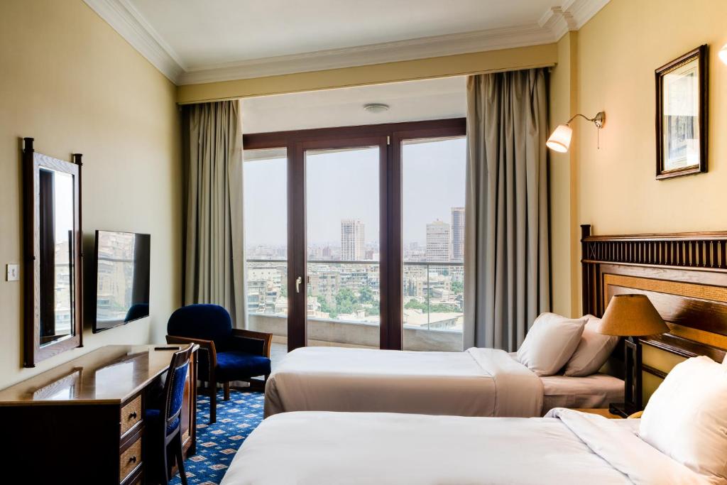 Postel nebo postele na pokoji v ubytování Om Kolthoom Hotel