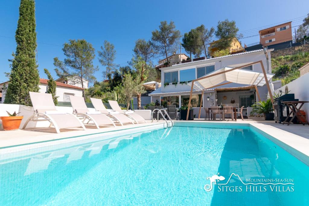 a villa with a swimming pool and a house at Beautiful Villa Encanto with private pool in Olivella