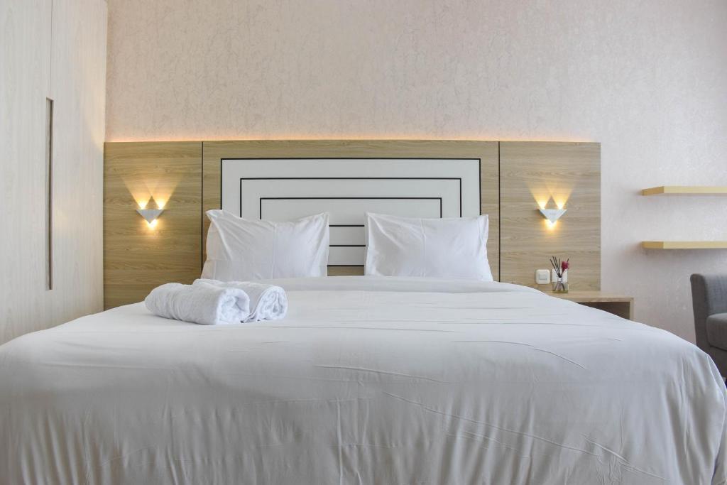 Ένα ή περισσότερα κρεβάτια σε δωμάτιο στο Fully Furnished with Cozy Design Studio at Menteng Park Apartment By Travelio