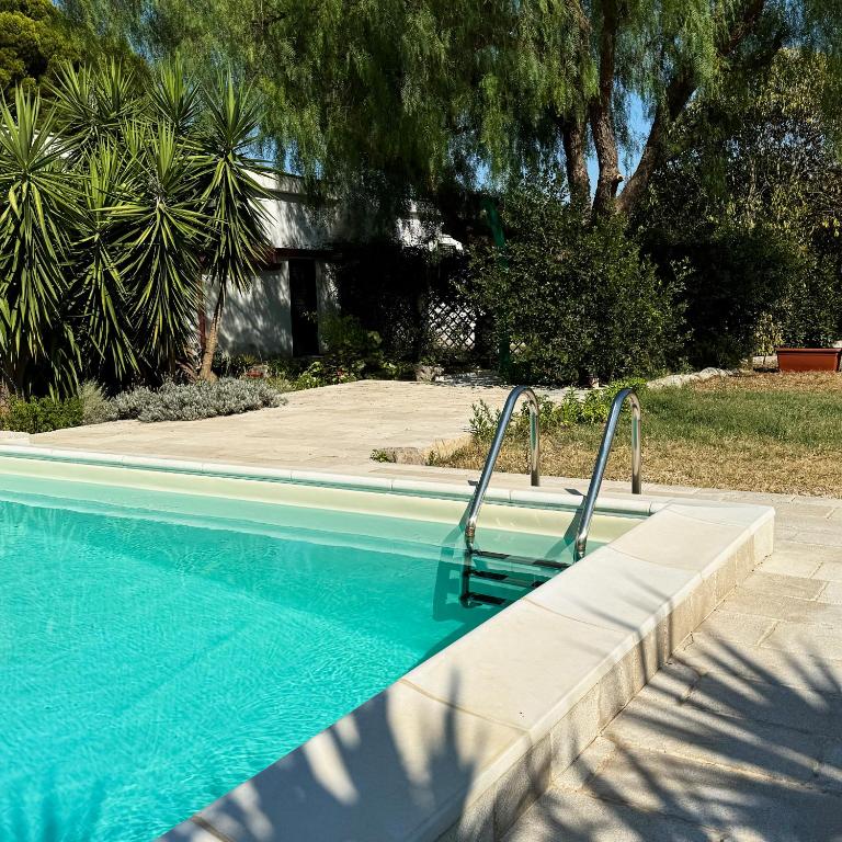 a chair sitting next to a swimming pool at Il Sentiero in Bari