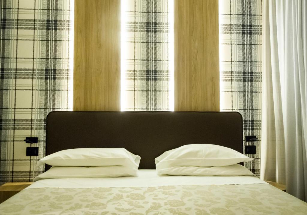 Postel nebo postele na pokoji v ubytování Hotel Ombra
