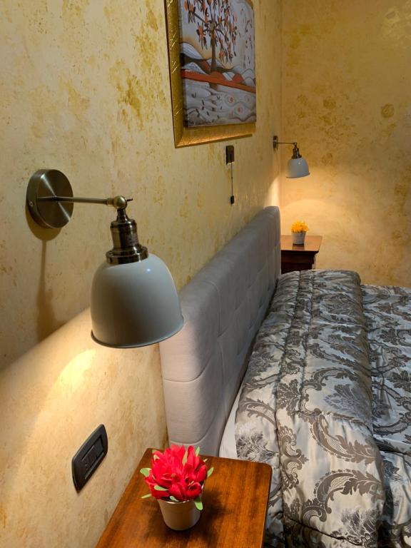 a bedroom with a bed and a table with a lamp at da Ercole all'Orecchietta in Candela