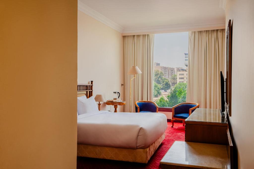 Postel nebo postele na pokoji v ubytování Om Kolthoom Hotel