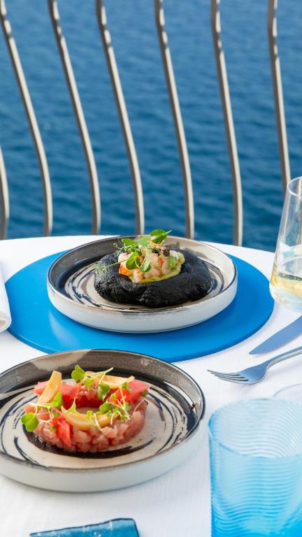 two plates of food are sitting on a table at Hotel Villa Pandora in Maiori