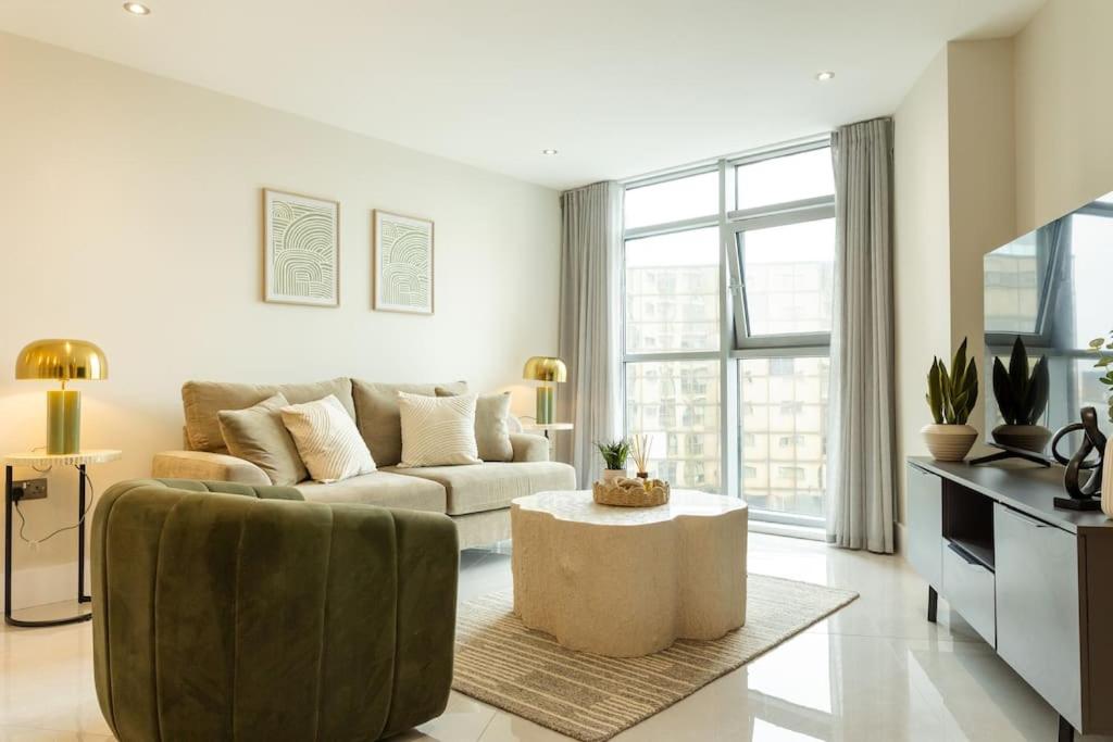 a living room with a couch and a table at Elegant City Centre Apartment 2 Bedroom With Free Parking in Cardiff