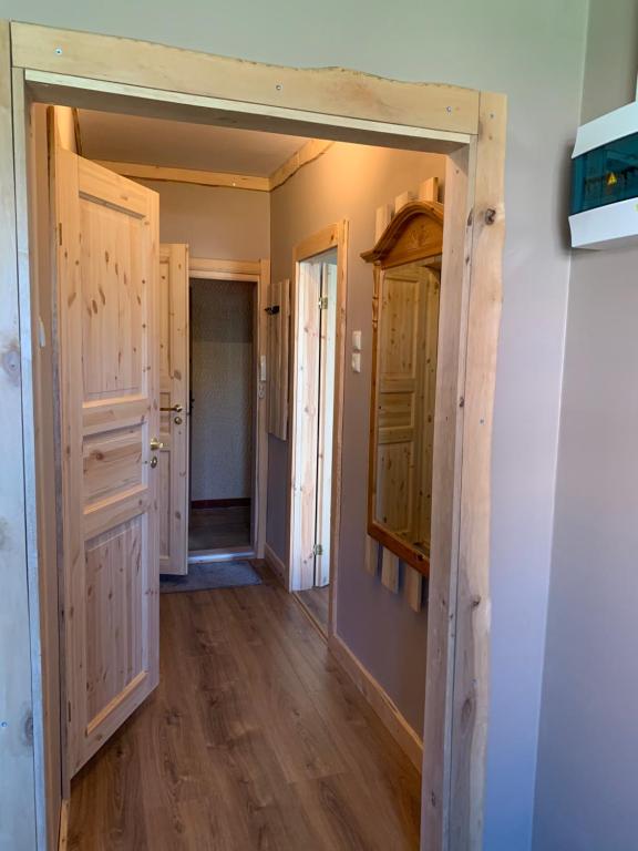a hallway with wooden floors and doors in a house at 1-bedroom 2 big beds MV64 in Tartu