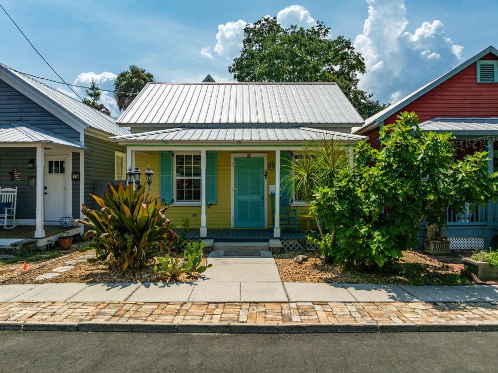 a yellow house with a tin roof at Casa Amarillo l Steps to Historic District in Saint Augustine