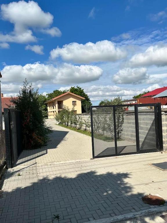 a gate in front of a house with a fence at Penzion Baffi in Topoľníky