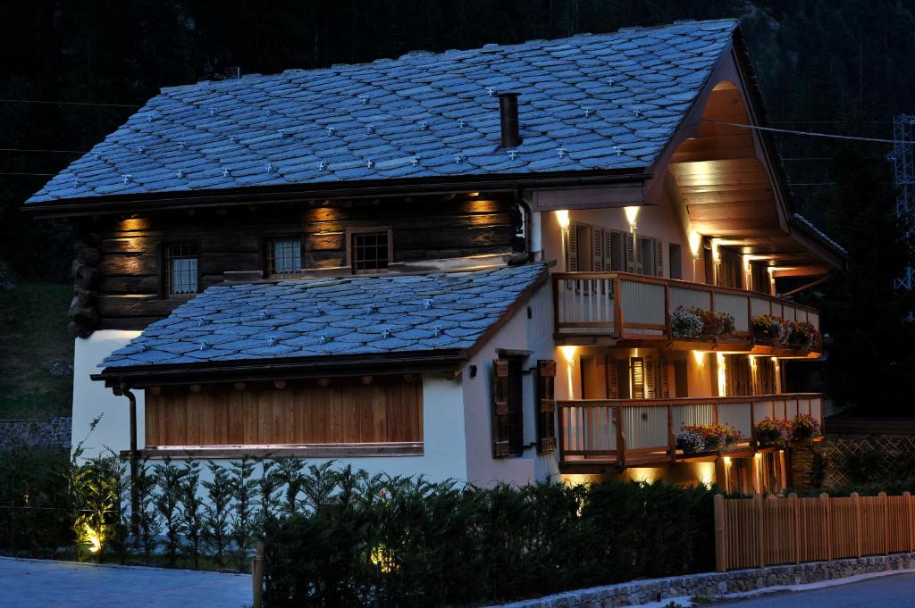a house with a roof with lights on it at Historic Residenze Loo Bach in Gressoney-Saint-Jean