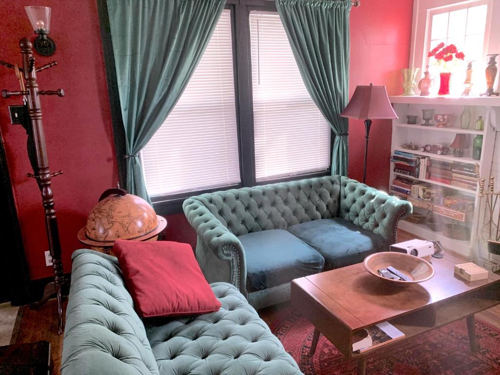 a living room with a couch and a table at Dr. Yaple's Art Deco House in Lafayette