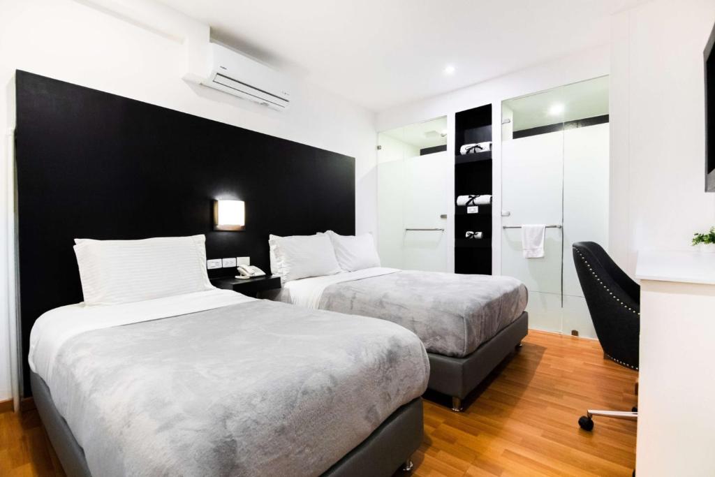 Postel nebo postele na pokoji v ubytování Hotel Z3 Pereira