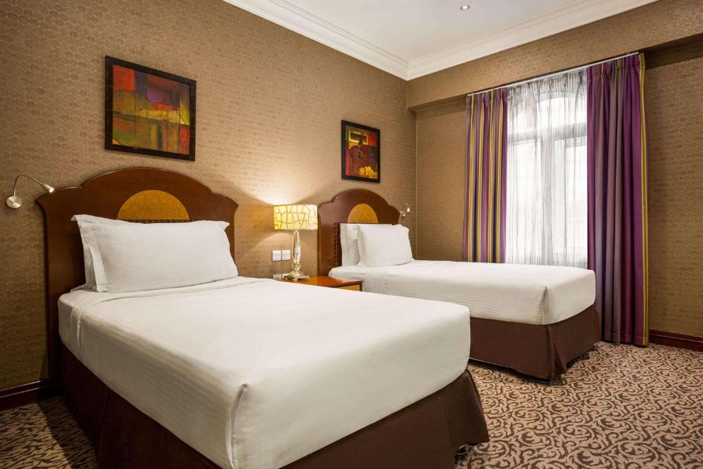 Voodi või voodid majutusasutuse Grand Regency Doha, Trademark Collection by Wyndham toas