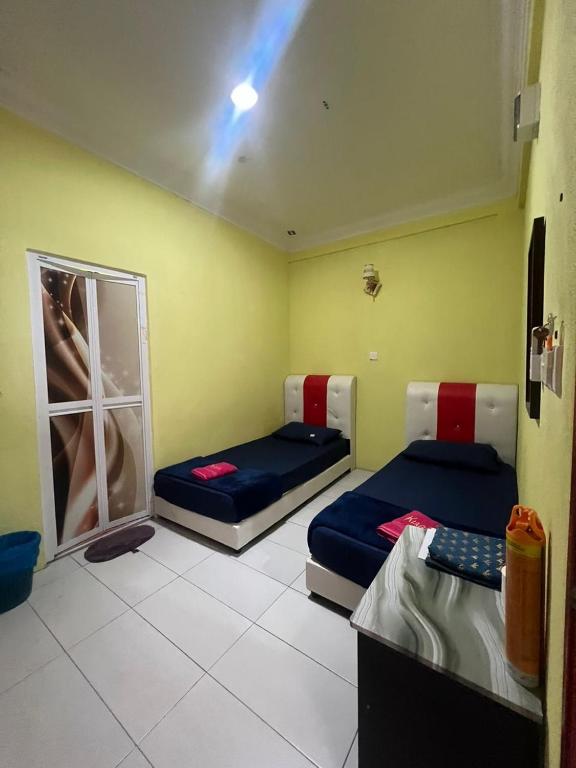 Postel nebo postele na pokoji v ubytování Perhentian Kiara