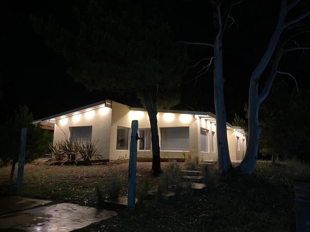 a house with lights on the side of it at night at Casa en Costa Esmeralda in Costa Esmeralda