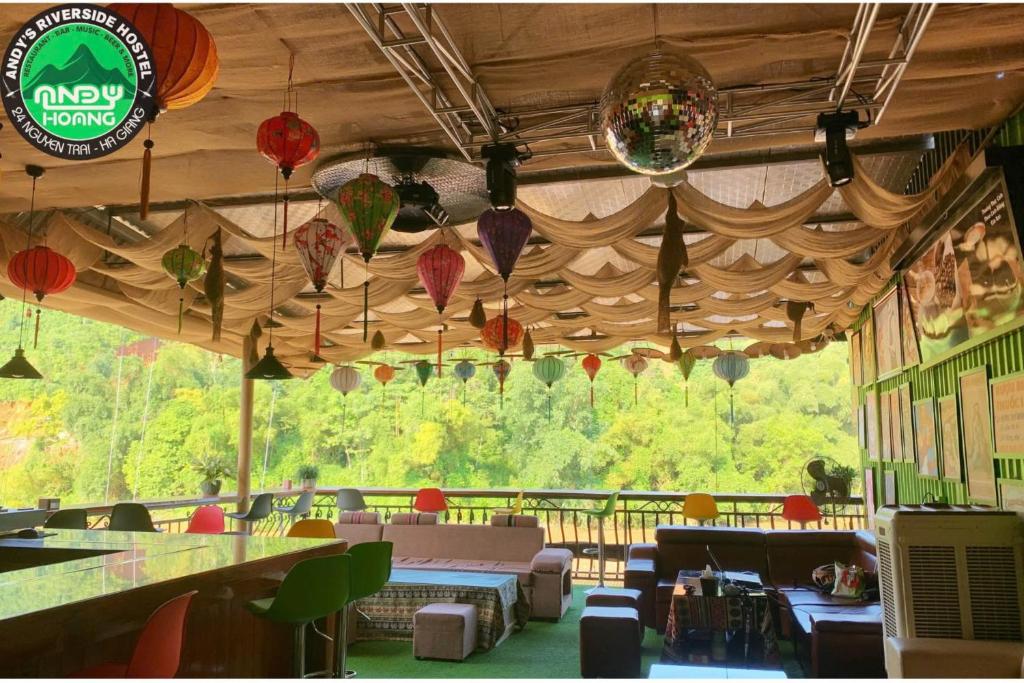a restaurant with colorful umbrellas hanging from the ceiling at Andy Hoang Riverside Hostel Bar Restaurant Music Beer & More in Ha Giang