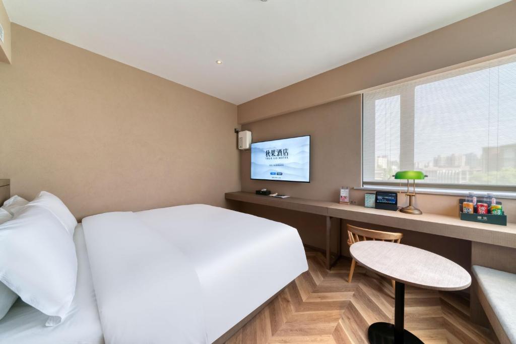 Postel nebo postele na pokoji v ubytování True Go Hotel Shanghai Xujiahui