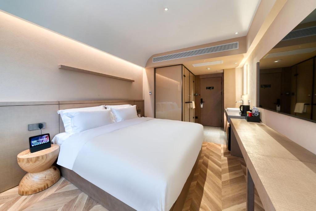 Postel nebo postele na pokoji v ubytování True Go Hotel Shanghai Xujiahui