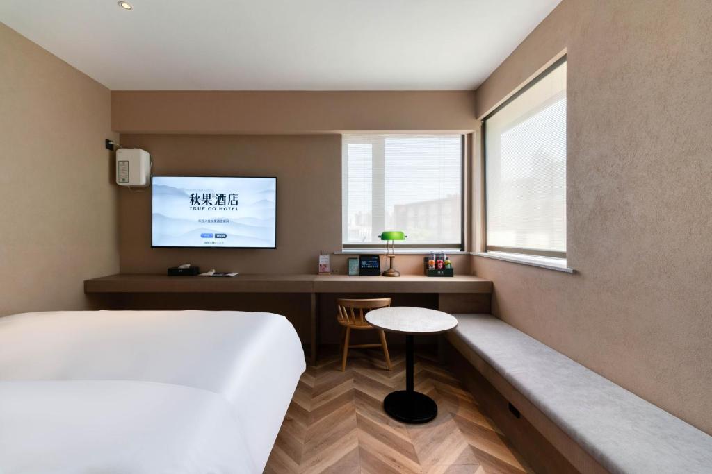 Postel nebo postele na pokoji v ubytování True Go Hotel Shanghai Xujiahui