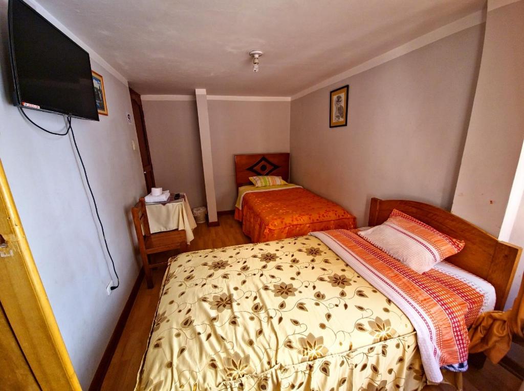 Postel nebo postele na pokoji v ubytování Hospedaje Qoricha'skas
