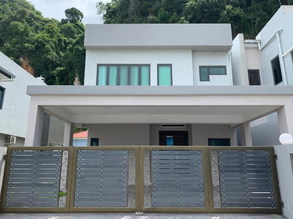 a house with a gate in front of it at Hillside House, Ipoh Garden, Max 9 pax, Hillview, No parties & events, No pets in Ipoh