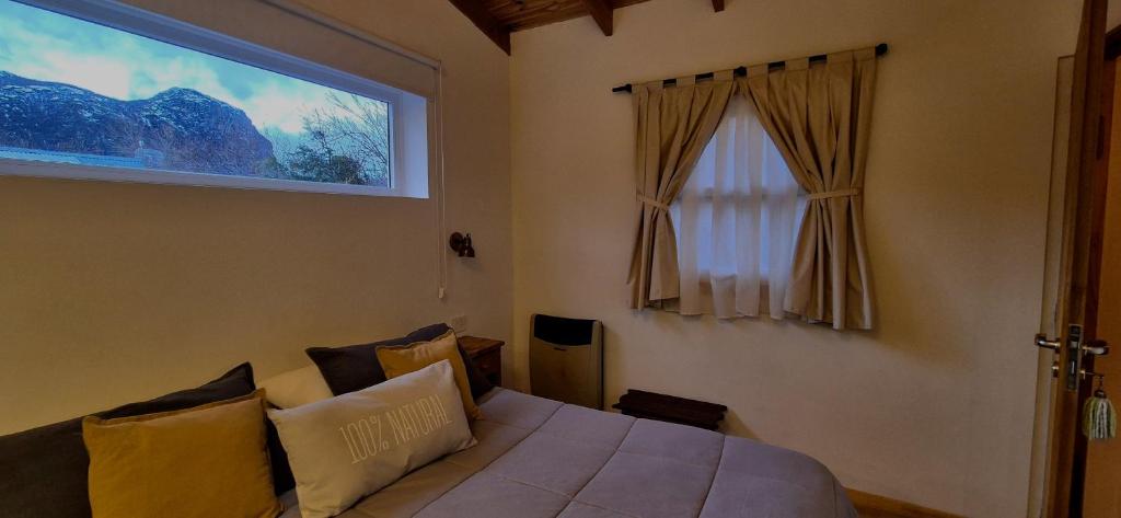 Postel nebo postele na pokoji v ubytování Hospedaje Mi Rincón El Chaltén
