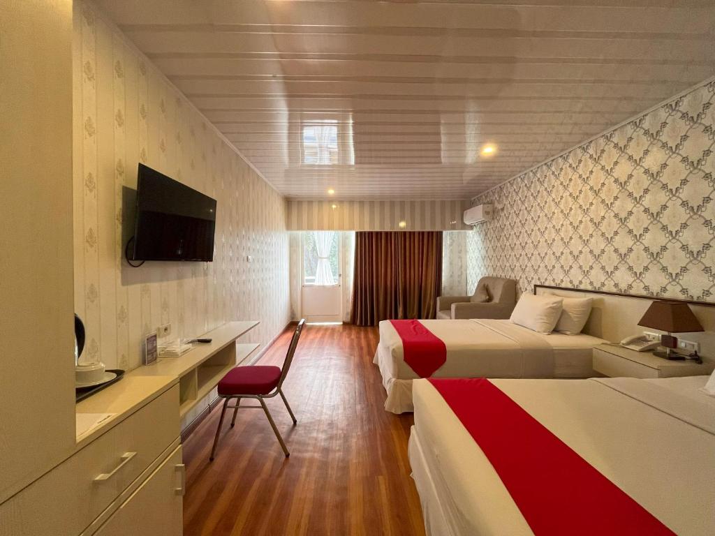 Postel nebo postele na pokoji v ubytování Grand Tamaro Hotel