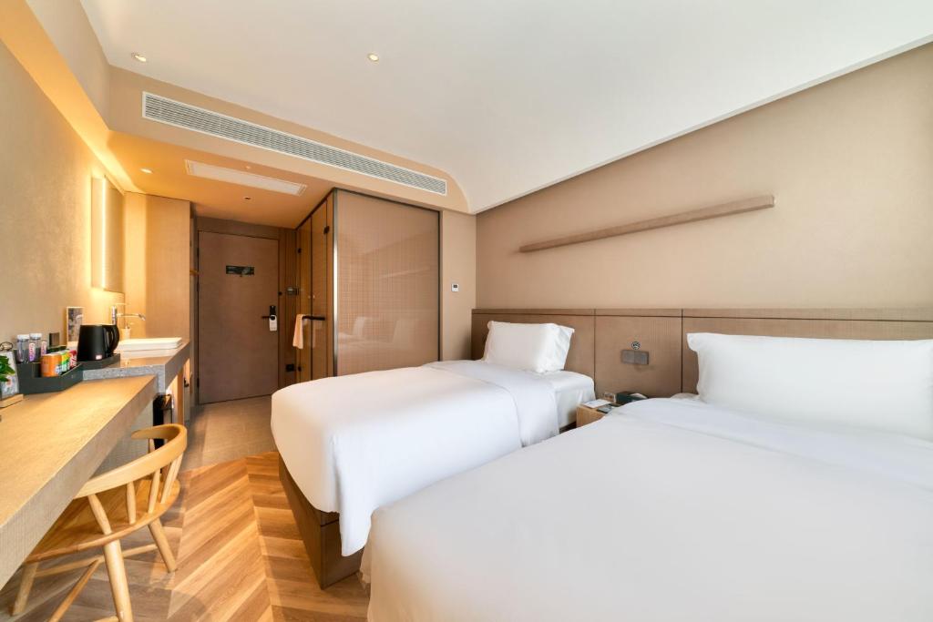 Postel nebo postele na pokoji v ubytování True Go Hotel Shanghai Xujiahui