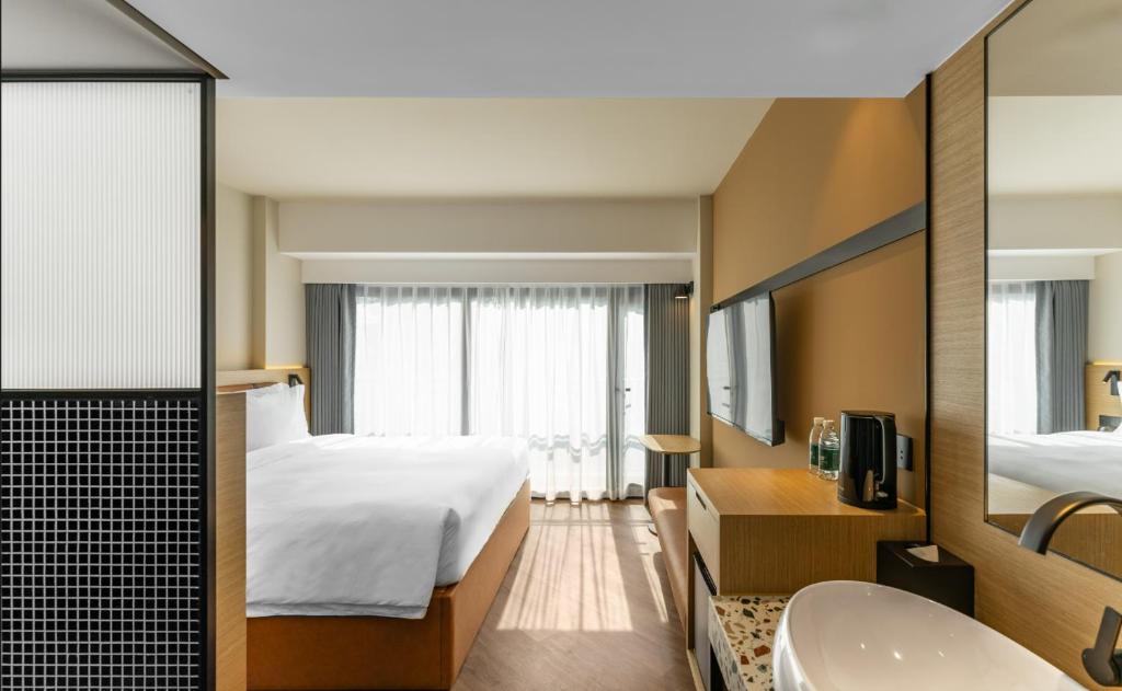 Postel nebo postele na pokoji v ubytování Mia Hotel - Shanghai Xuhui Jiaotong University