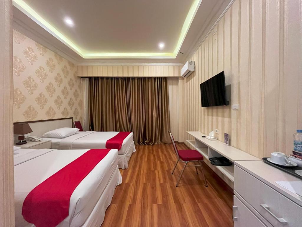 Postel nebo postele na pokoji v ubytování Grand Tamaro Hotel