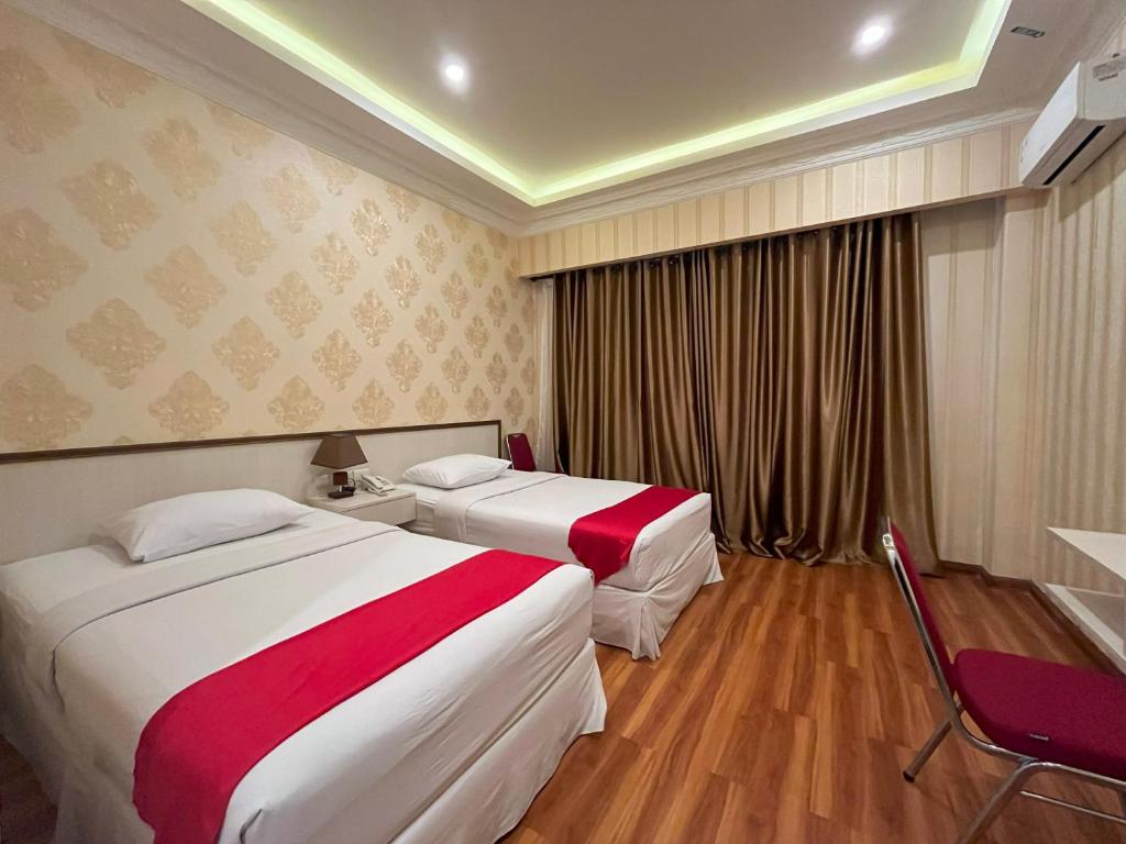Postel nebo postele na pokoji v ubytování Grand Tamaro Hotel