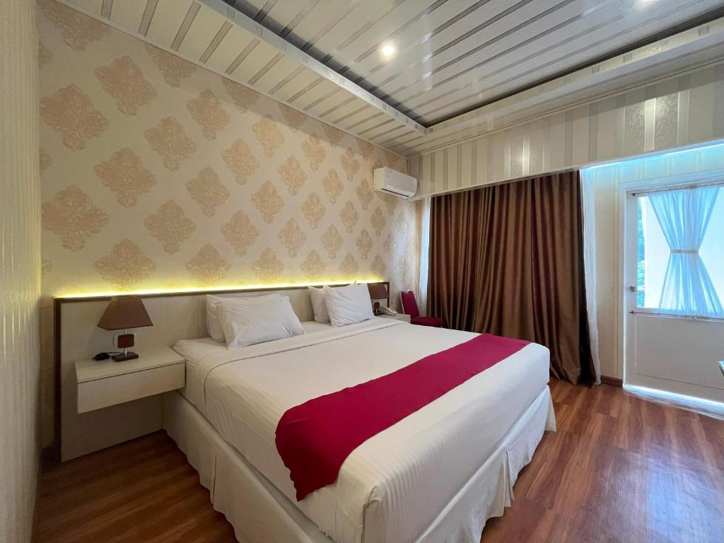 Postel nebo postele na pokoji v ubytování Grand Tamaro Hotel