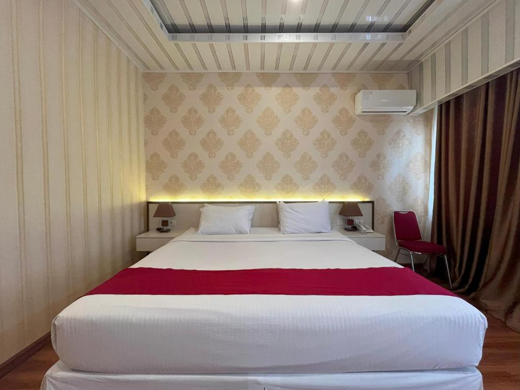Postel nebo postele na pokoji v ubytování Grand Tamaro Hotel