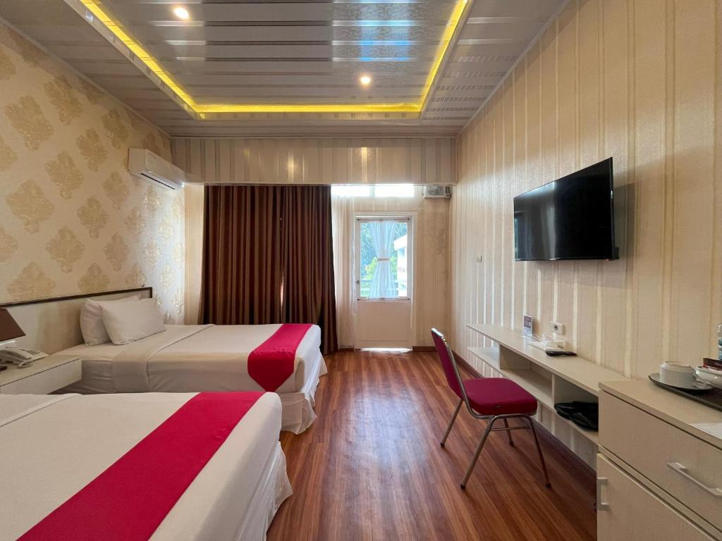 Postel nebo postele na pokoji v ubytování Grand Tamaro Hotel