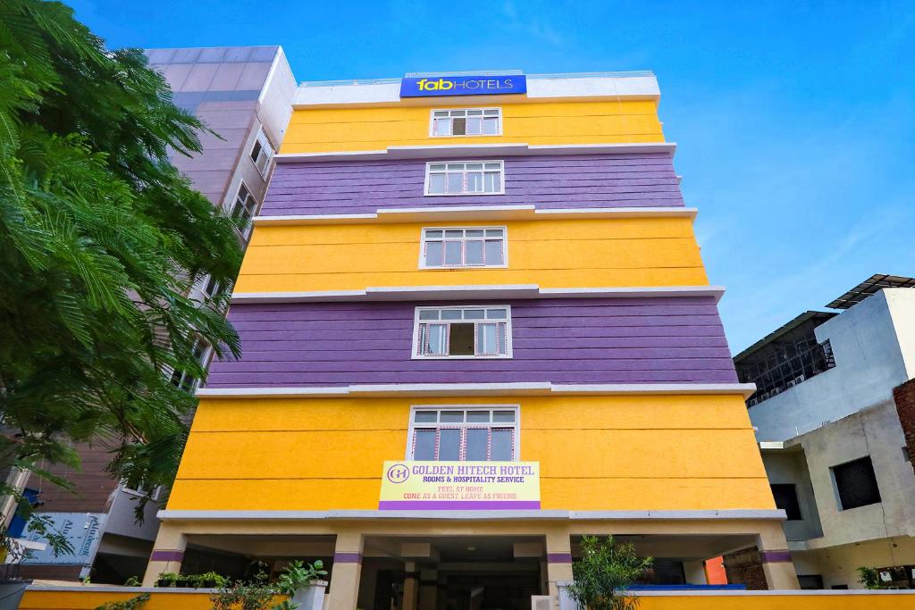 a brightly colored building with a sign on it at FabHotel Golden Hitech - Nr Hitech City in Hyderabad