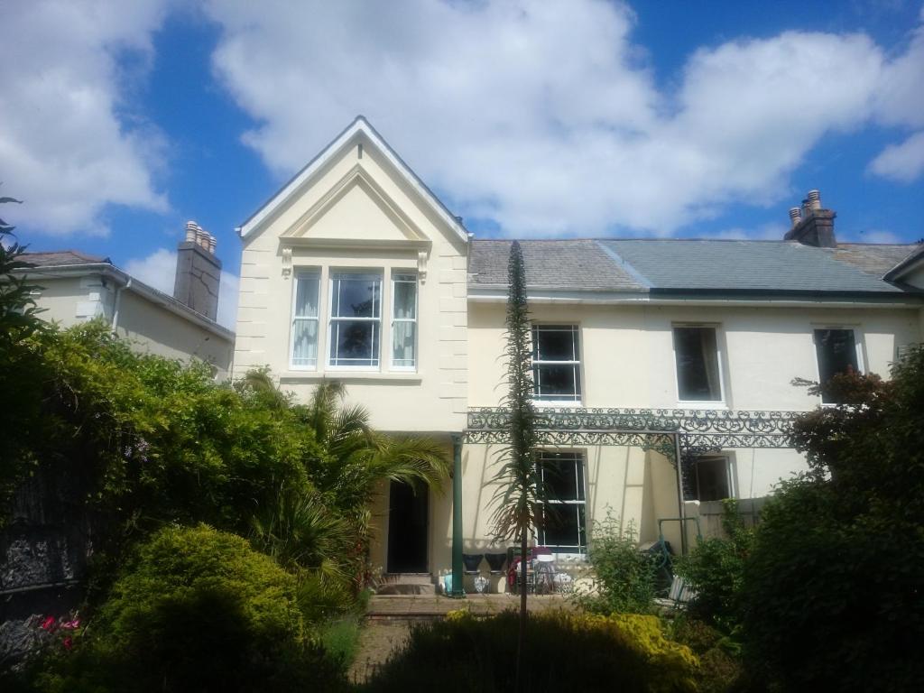 a white house with a roof at Bankside Bed & Breakfast in St Austell