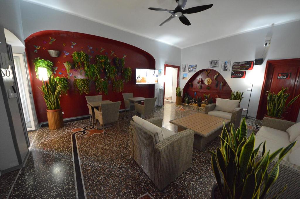 a living room with a couch and a table and chairs at Mami Affittacamere in Genova