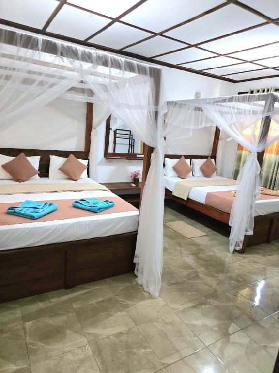 Postel nebo postele na pokoji v ubytování Sigiriya Paradise Inn