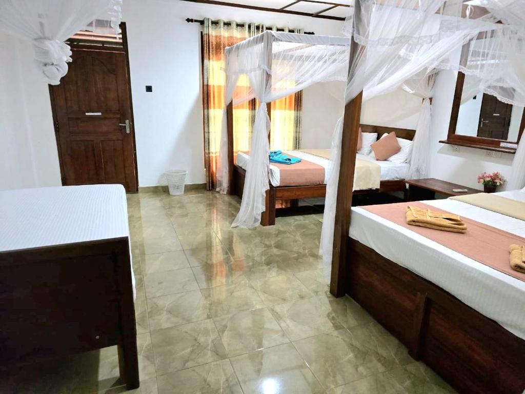 Postel nebo postele na pokoji v ubytování Sigiriya Paradise Inn