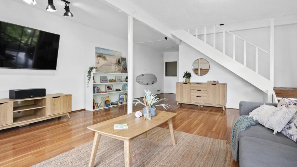 un salon avec un canapé et une table dans l'établissement Copacabana Tranquil Escape Views, Pet Friendly On Request Accom Holidays, à Copacabana