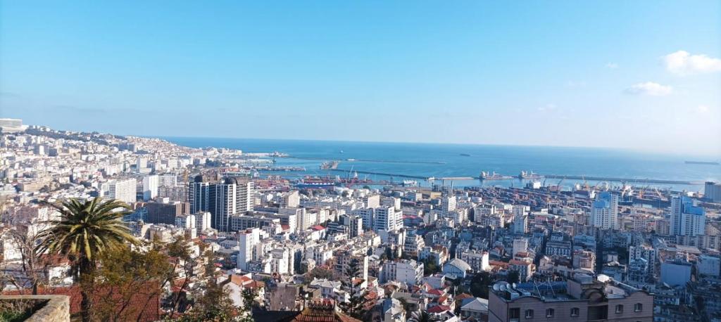 an aerial view of a city with the ocean at Alger avec vue imprenable sur la Baie d'Alger Piscine Balcon Terrasse in El Mouradia